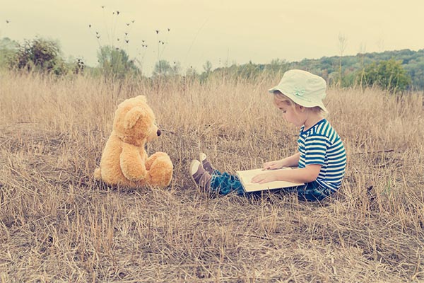 Cute girl reading book Teddy bear By Vyacheslav Vokov